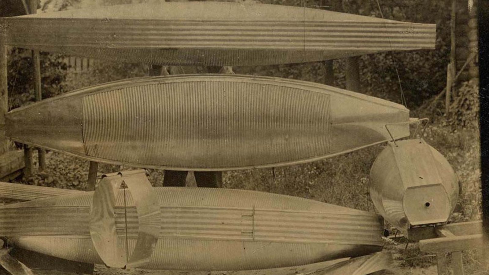 Four metal-clad airship models stacked on top of one another in Konstantin Tsiolkovsky's garden in Kaluga, 1913