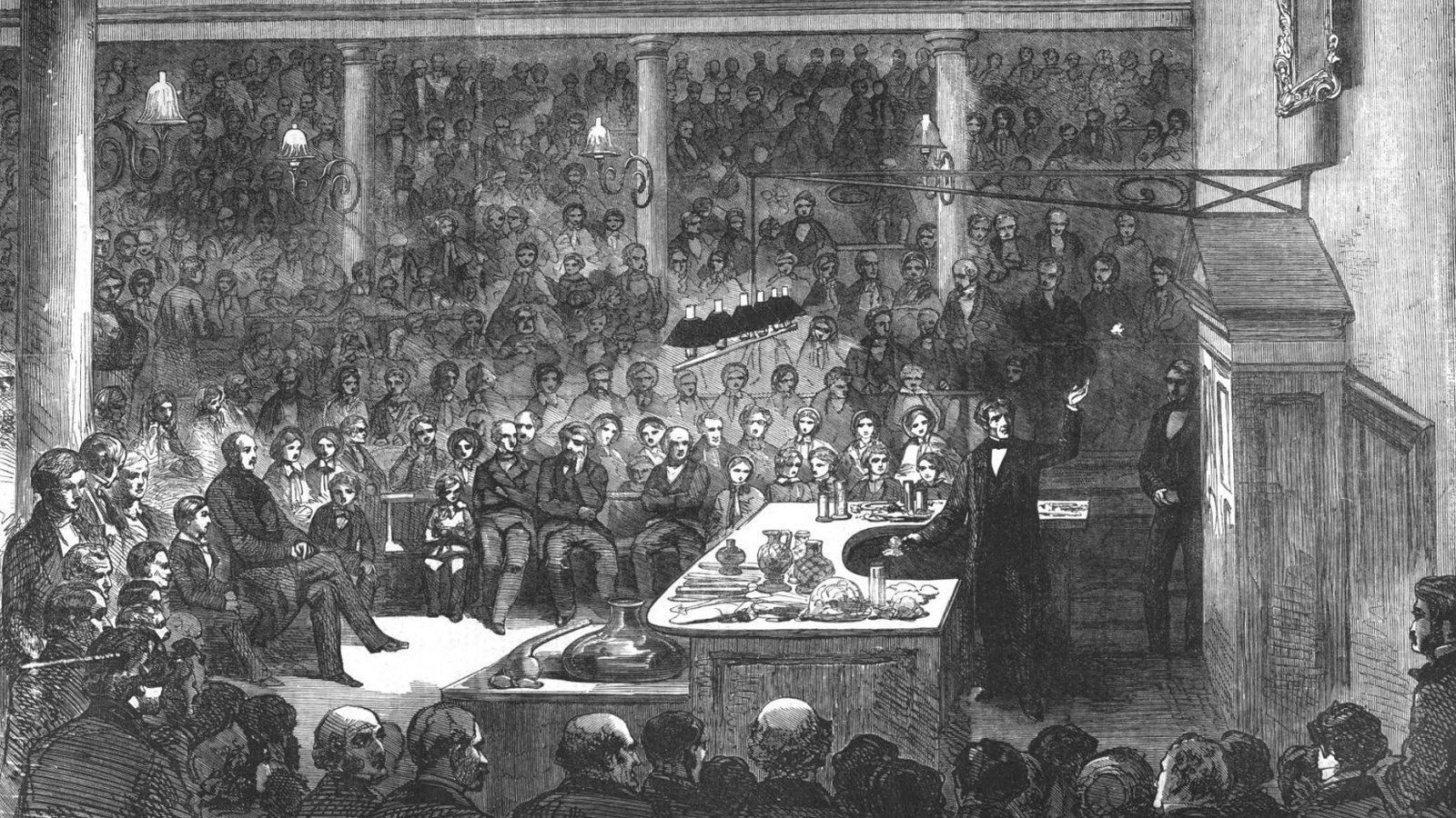 Michael Faraday lecturing to a large audience in the Royal Institution lecture theatre, an engraving